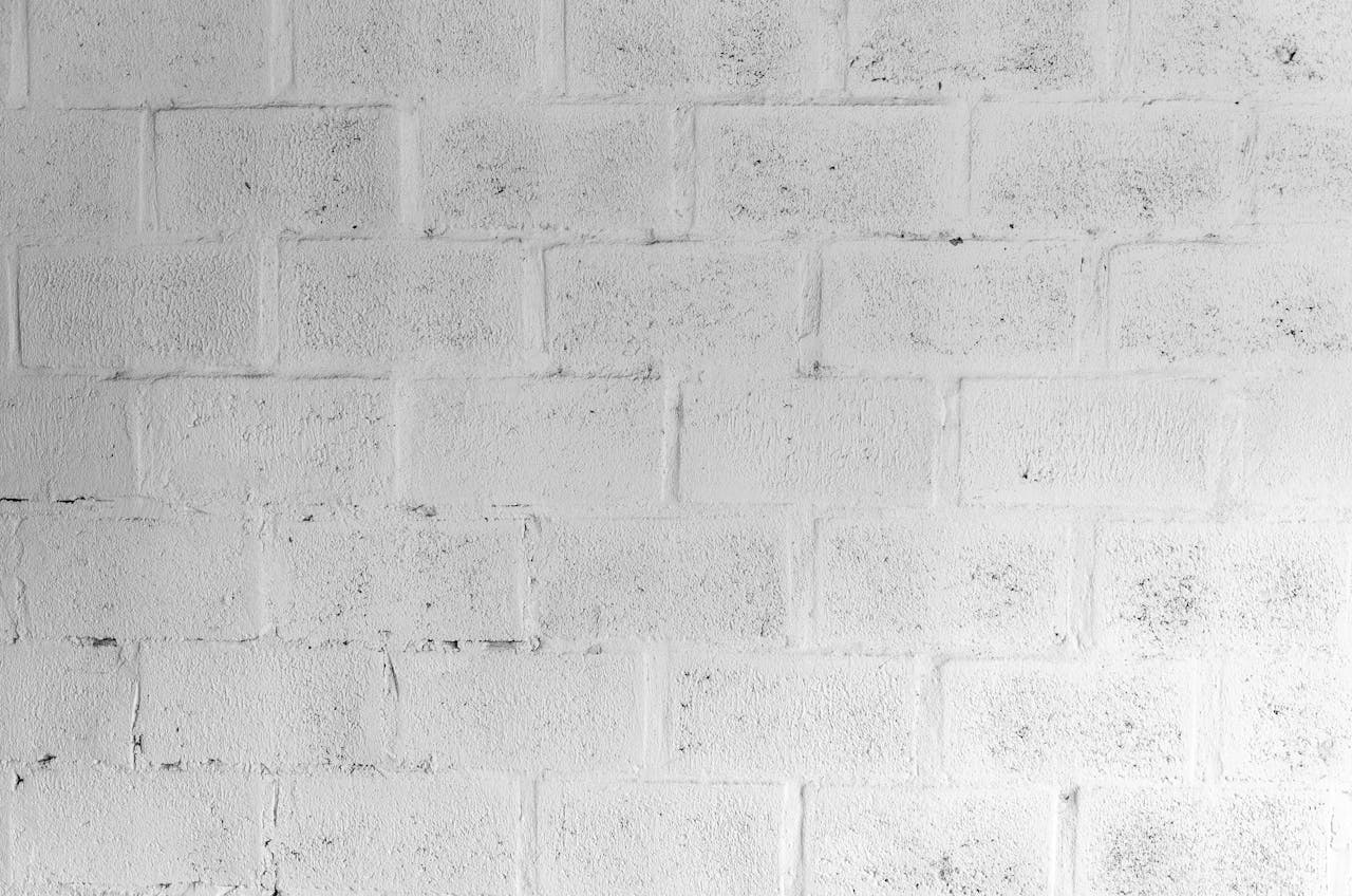 A textured white brick wall for use in design and architectural projects.