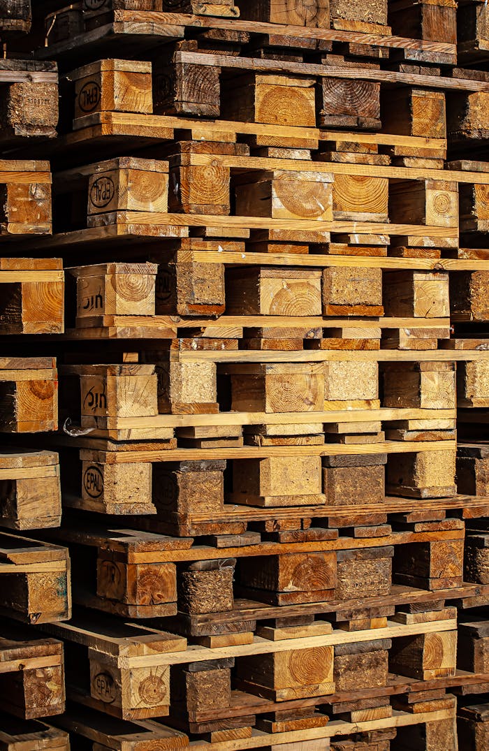 Close-up of stacked wooden pallets outdoors, showcasing industrial storage.