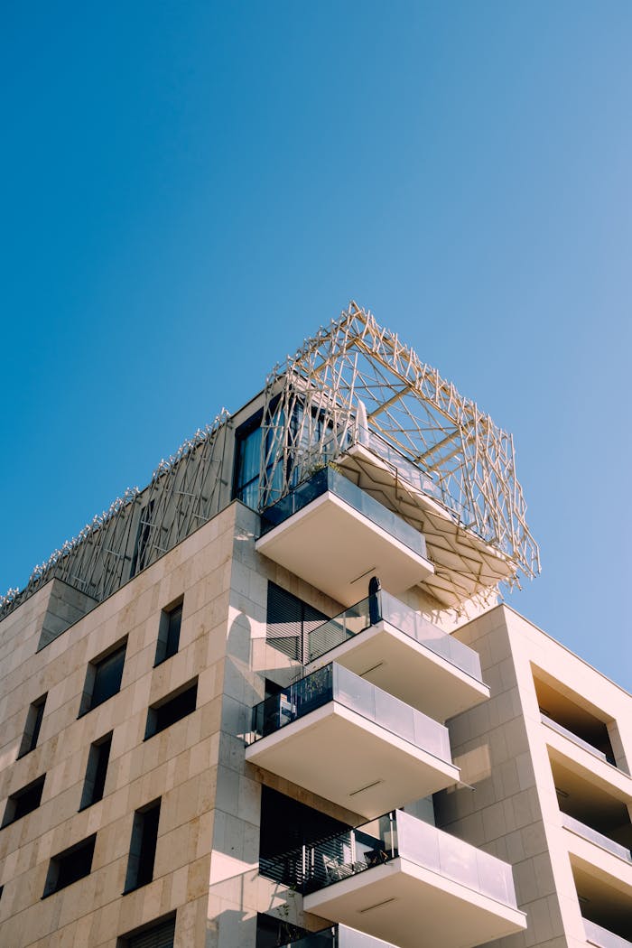 Contemporary building with unique scaffolding against a clear blue sky.